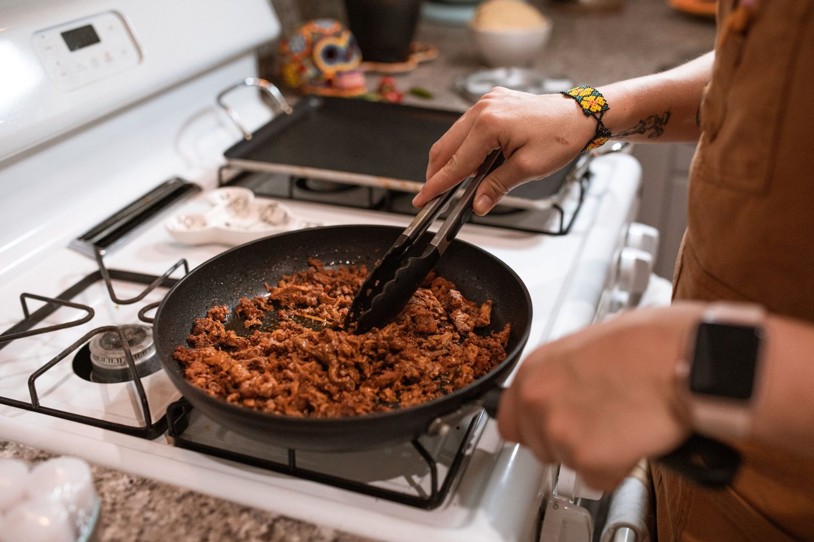 Seasoned ground beef cooking in a skillet on the stovetop