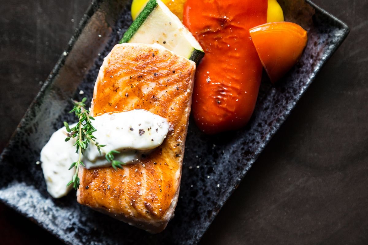 Seared salmon fillet served with roasted vegetables