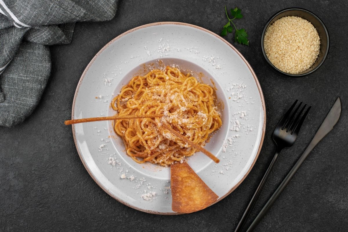 Plate of spaghetti topped with grated cheese