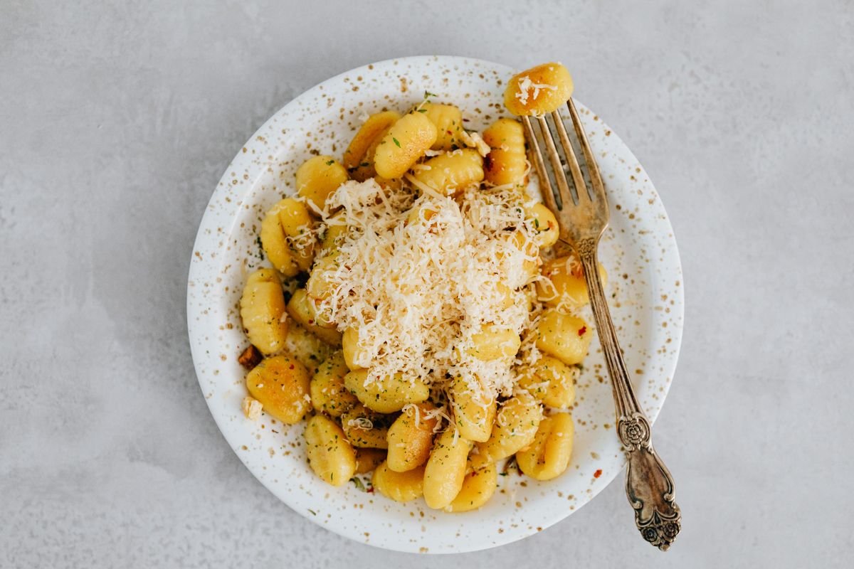 Plate of gnocchi topped with grated cheese