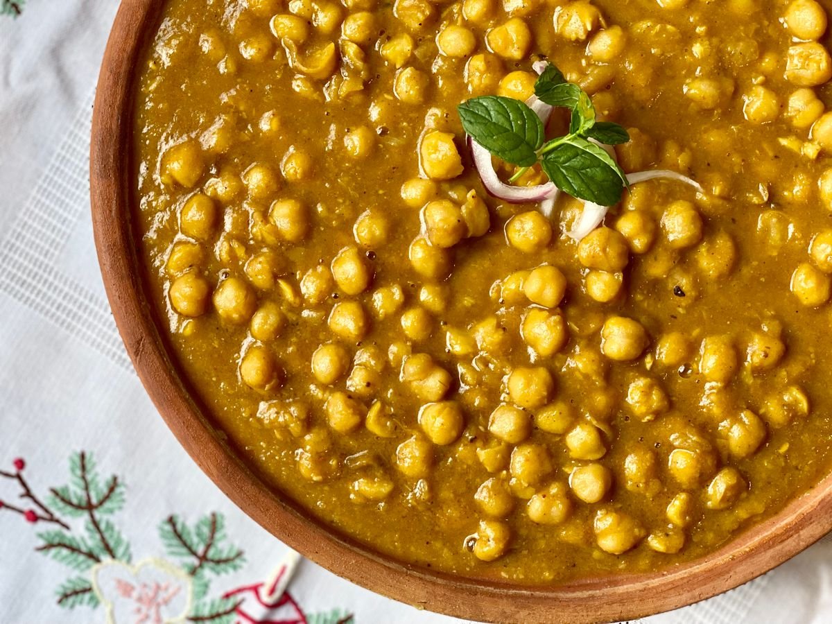 Close-up of a chickpea curry in a wooden bowl
