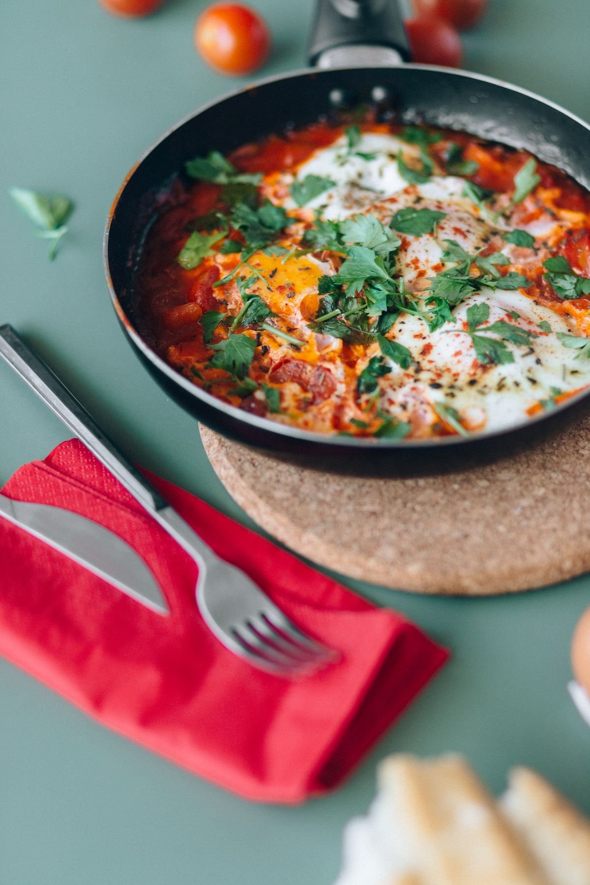 Shakshuka with eggs poached in tomato sauce in a skillet