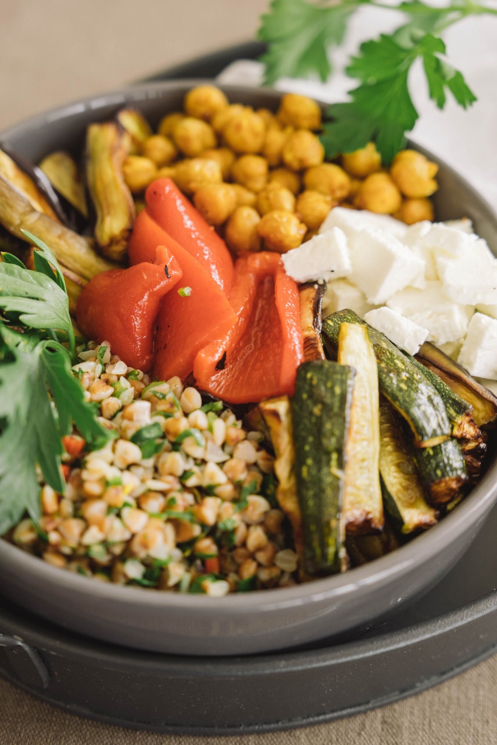 Mediterranean grain bowl with chickpeas, feta and roasted vegetables