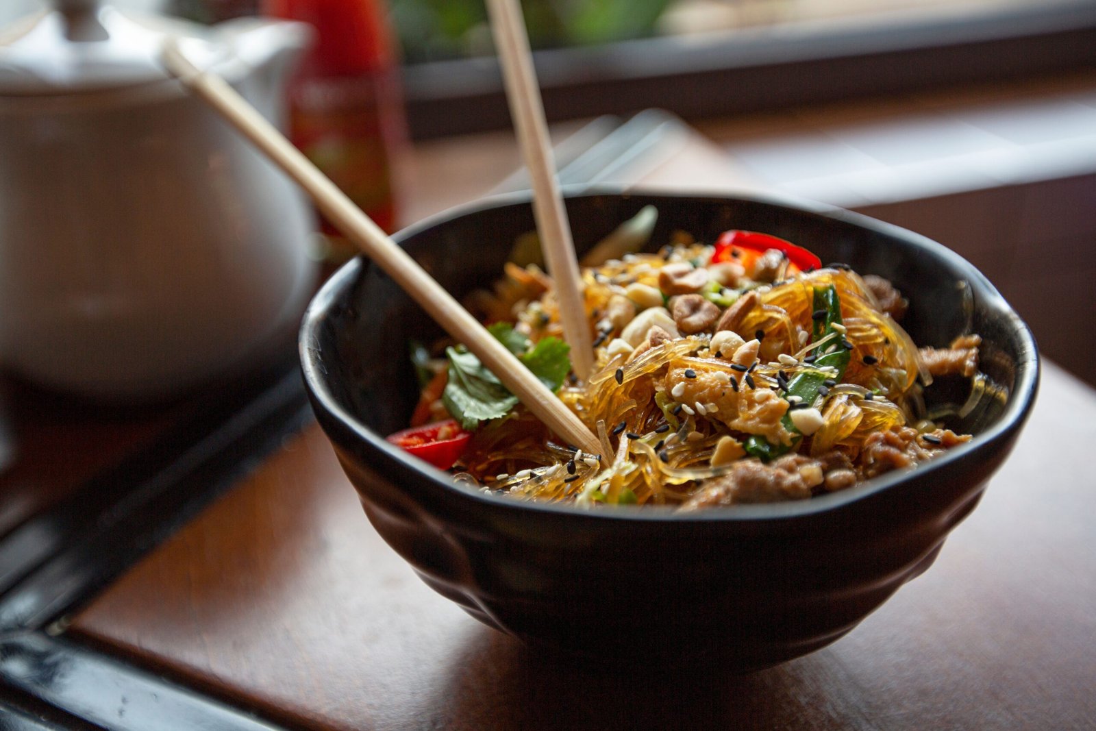 Cold peanut soba noodle bowl with cucumber and herbs